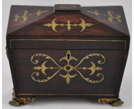 A Regency cut brass inlaid rosewood sarcophagus tea caddy on cast paw feet, w:20cm 