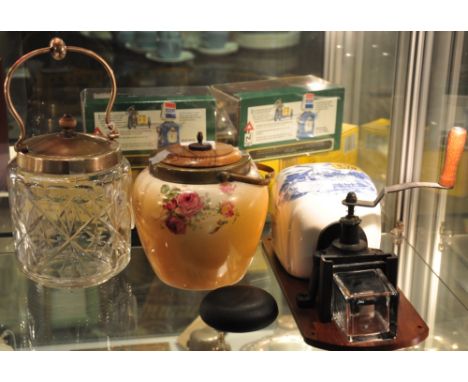 A Dutch blue and white pottery coffee grinder together with an earlier ceramic biscuit barrel and a glass barrel 