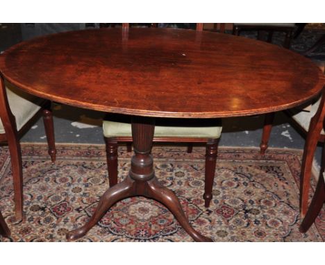 A George III design dining table with cross banded oval tilt top on cabriole tripod base 