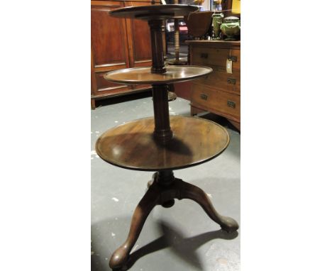 A George III mahogany 3 tier dumb waiter, the graduated revolving tiers on gun barrel column and downswept tripod, H. 102cms
