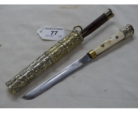 A 19th century Korean lady's Jangdo dagger,ivory grips with relief embossed unmarked white metal scabbard and hardwood chopst