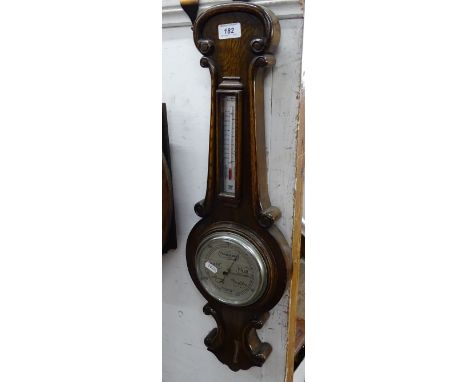 A carved oak aneroid barometer by James Lucking, Birmingham