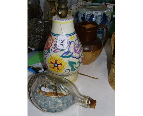 A Doulton jug, a Poole pottery table lamp and a ship in a bottle.