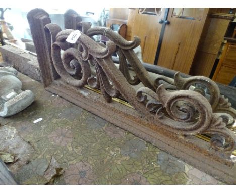An ornate cast-iron lamp bracket.