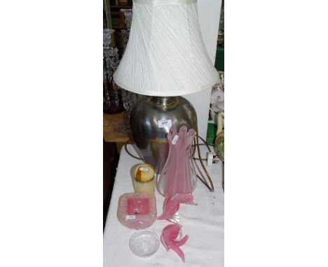 A metal table lamp and shade, pink glass vases and figures