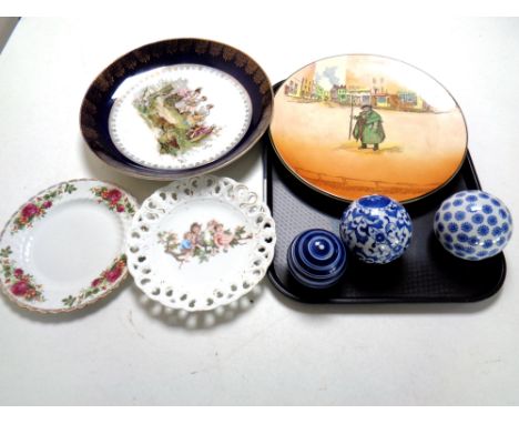 A tray containing assorted ceramics including a Royal Doulton Tony Weller Charger, assorted wall plates, three decorative blu