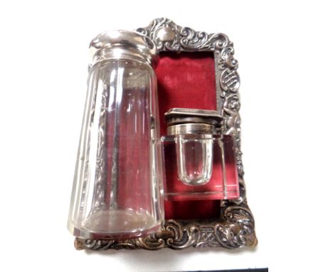 A silver photograph frame, a silver lidded inkwell and a similar dressing table pot