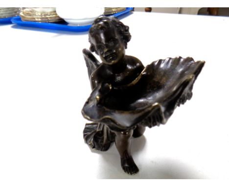 A 19th century patinated bronze putto holding an oyster shell-shaped dish (height 12cm) 