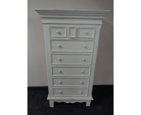 A contemporary white painted eight drawer chest together with similar bedside cabinet and small lamp table  