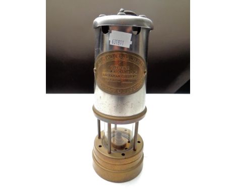 A British coal mining brass and chrome miner's lamp