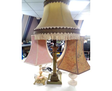 A brass and onyx table lamp with two others