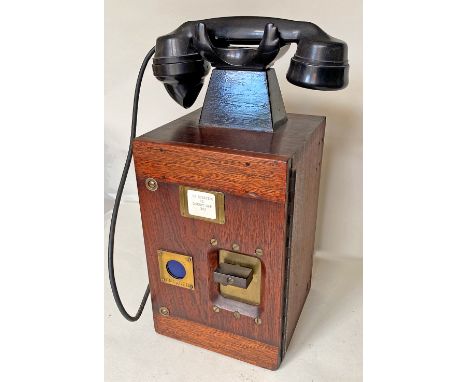 An unusual wood cased Signal Box Telephone with bakelite handset in top cradle. The front has a rotary count-down switch used