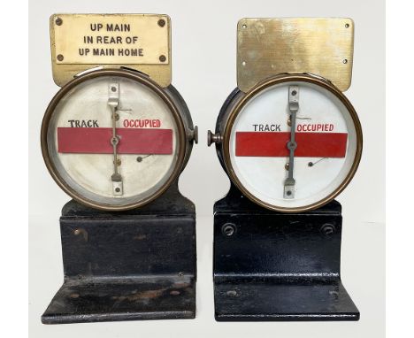 GWR Brass cased Signal Box Track Indicators mounted on cast iron, right angle shelf brackets. One has an ivorine plate affixe