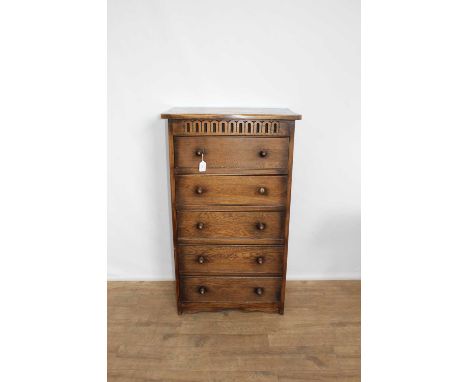 Narrow oak chest of five drawers, 61cm wide, 38cm deep, 104cm highGeneral condition is good, however there is a water stain o