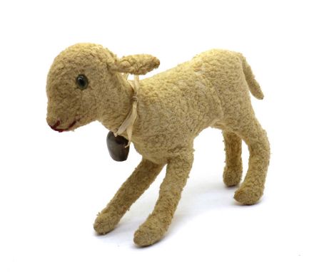 A Steiff lambearly 20th century, straw-filled, with green glass eyes, red-stitched nose, and 'Steiff' button to left ear22cm 