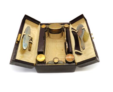 A silver mounted vanity case by J.C Vickery,comprising a handheld brush,13.3cm long, a brush, 12cm long, and mirror, 13.3cm h
