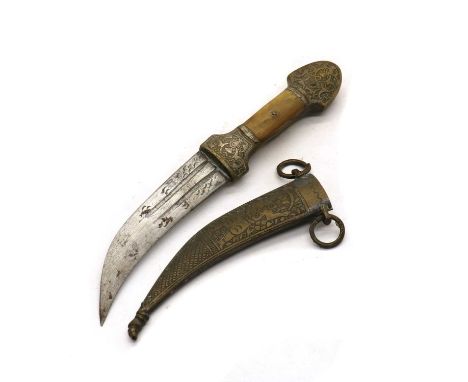 A small Middle Eastern brass dagger in scabbard,with horn handle, the scabbard with engraved figures23cm long overallSome wea