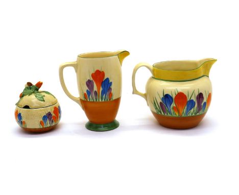 A collection of Clarice Cliff 'Crocus' pattern items,comprising a coronet water jug, 15cm high, a Perth jug, 13cm high, a dru
