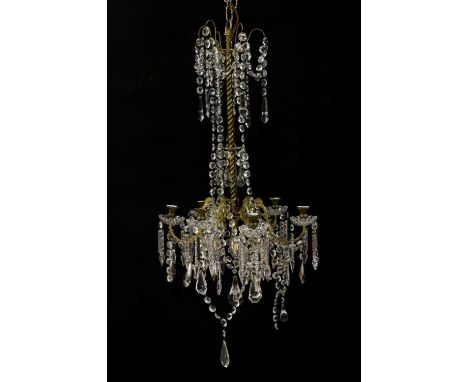 A brass six light chandelier,early 20th century, later converted for electricity, with a spiral brass column and six scrollin