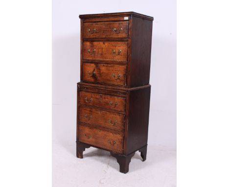A 1920's country oak tallboy chest on chest of drawers. Raised on bracket feet having an upright twin section chest of gradua