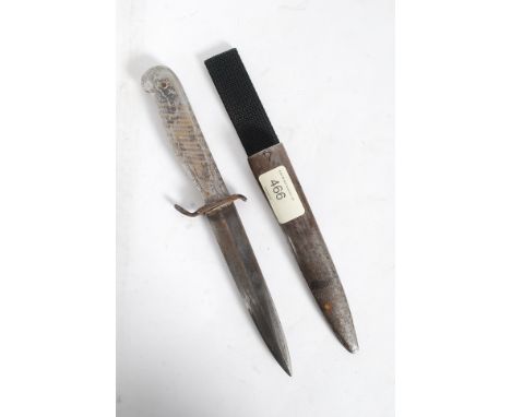 An acrylic handled 2nd world war dagger being unmarked, likely military issue complete with the metal scabbard - formerly pro