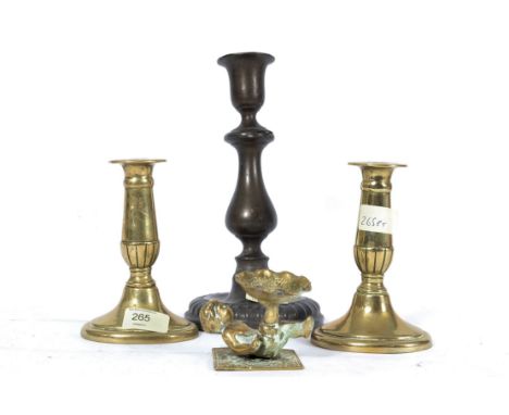 A pair of 19th century candlesticks together with an 18th century pewter candlestick and a small brass cherub tealight candle