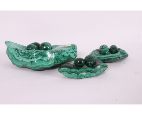 A large Malachite mineral stone formed into an ashtray together with smaller malachite ashtrays and egg shaped ornaments. Mea