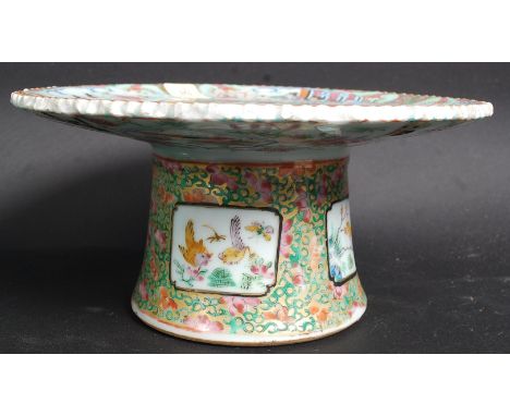 A 19th century Cantonese / Canton ceramic tazza decorated with family / court scenes raised on inverse tapered base.