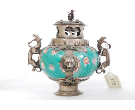 A Chinese white metal and ceramic incense burner adorned with twin fu-dog handles with monkeys and frogs to the top. Measures