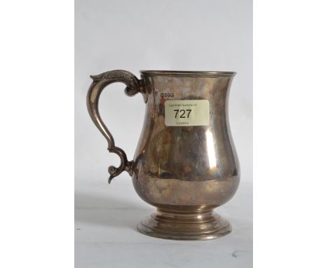 A silver hallmarked tankard with leaf design to handle, tapered base with hallmarks clearly to rim. 375.5g