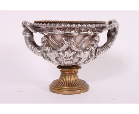 An unusual 19th century silver and gilt metal reproduction Warwick Vase. Of rococo form having silver plate body of rococo st