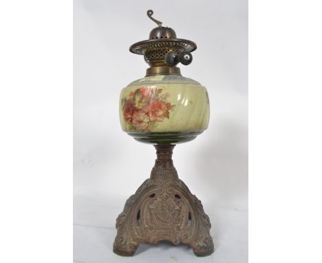 A 19th century Duplex Oil lamp having a cast pierced metal base with ceramic reservoir with wick atop. Measures: 40cms H.