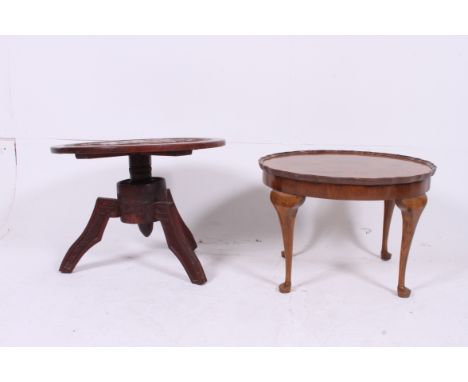 A Queen Anne walnut coffee / occasional / lamp table being raised on cabriole legs together with a hardwood carved coffee tab