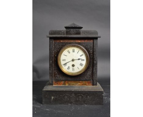 A Victorian slate mantle clock having inset enamel face with roman numeral chapter ring.  An 8 day movement set to rear compl