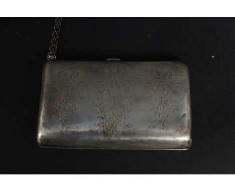 A hallmarked silver ladies purse (marks rubbed) complete with chain and decorated to one side. 148.2g