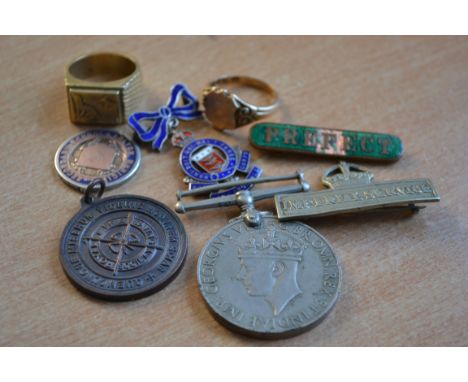 A collection of medals to include Imperial Service, silver and enamel Army & Ordnance, silver school badge, prefect badge, me