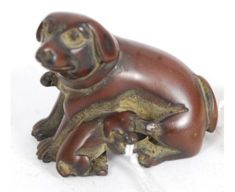 A Japanese oriental carved wood netsuke of a dog