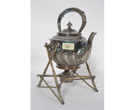 A good early 20th century Silver plate spirit kettle raised on shaped x-frame stand with twin rests, complete with the spirit