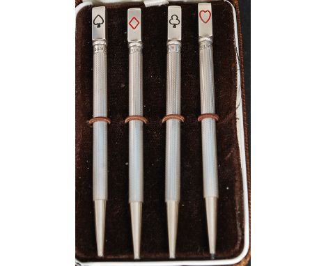 A fabulous cased set of silver stamped bridge pens adorned to each with club, diamond, heart and spade motifs. Each weighing 