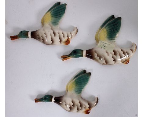 A set of retro mid 20th century ceramic Beswick style wall mounted flying ducks. Unsigned.