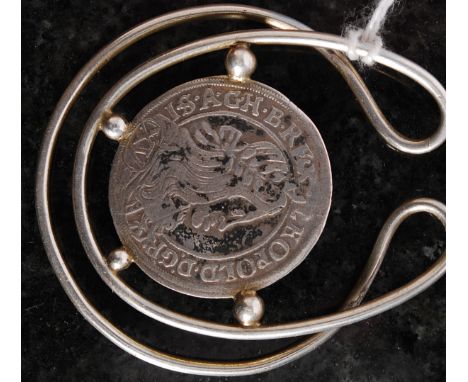 An Austrian silver 1661 Leopold Kreuzer coin mounted to a silver pendant of wirework and finial form. Weight 14.5g