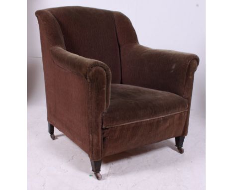 An Edwardian mahogany chesterfield armchair raised on tapered supports with ceramic castors with velour upholstery.