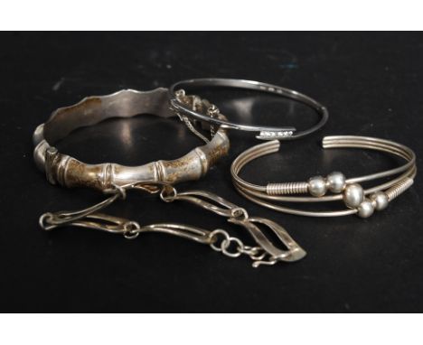 Four silver hallmarked and 925 white metal bangles. 590g