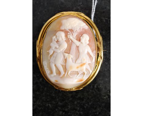 An 18ct gold ladies large cameo brooch. Unmarked / tests as 18k,the inset stone decorated with scenes of children playing wit