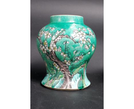 A 19th century Chinese prunice vase having green ground stylised with aubergine trunk and white flowers