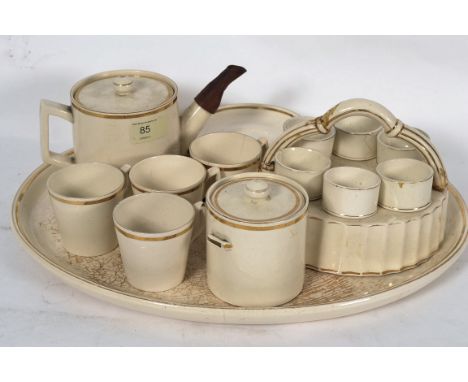 An unusual 19th century china tea service comprising tray, teapot plates etc together with an egg cup server with cups, teapo