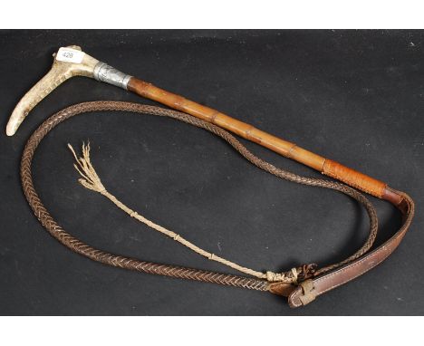 A hallmarked silver banded riding crop with horn handle and whip to base. 