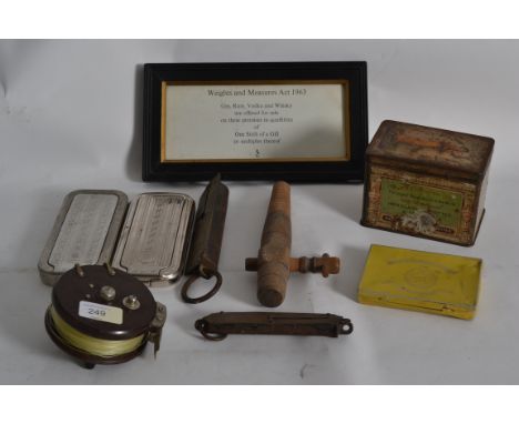 A collection of items to include brass scales, bakelite fishing reel, tins, razors etc along with a sign for Weights & Measur