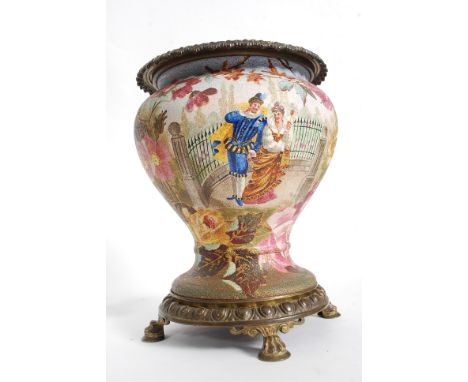 An early 20th century ceramic and brass lined planter / plant pot vase. The brass base raised on hairy paw feet having cerami