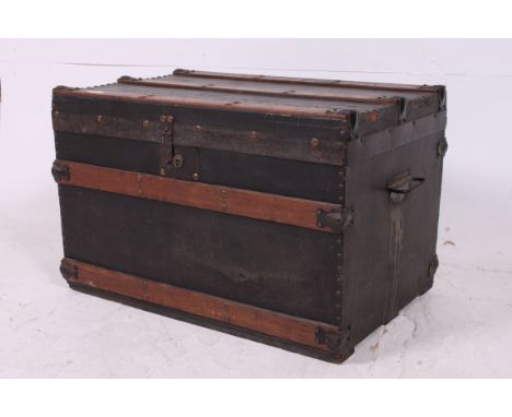 A 19th century Victorian wooden and canvas strapped steamer trunk having clasp handles to the sides with hinged top above. Me